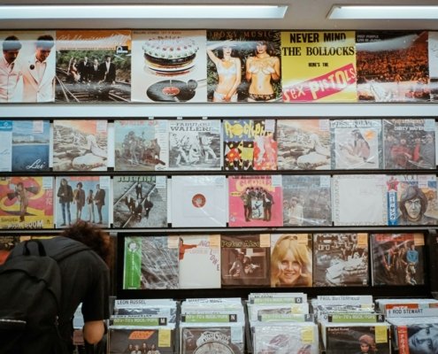 a man is looking at a wall of records